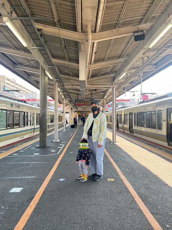 Yoko and Aki standing in the middle of a train platform at Ōji station, Nara