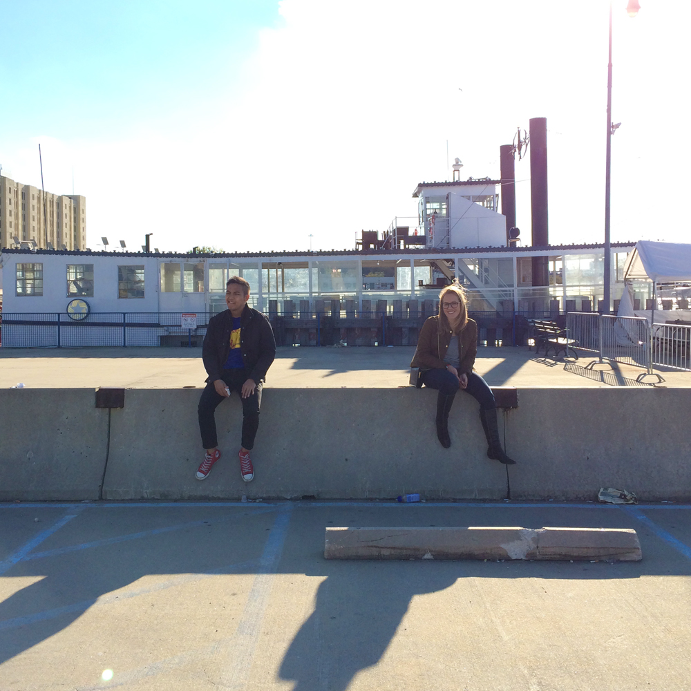 Explorers Kevin and Sophia, sitting on a road divider