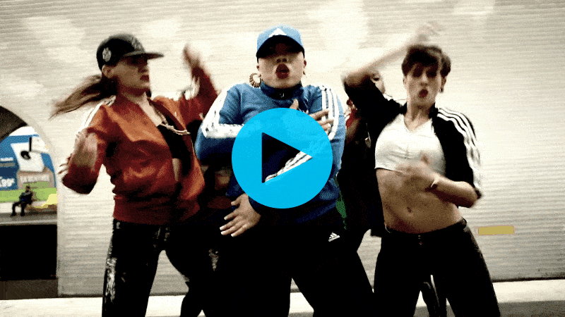 A GIF of Parris Goebel doing a chest pump, surrounded by dancers